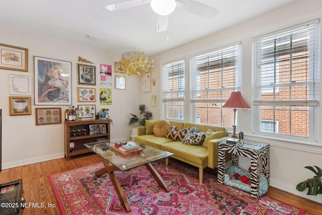 living area featuring ceiling fan and hardwood / wood-style flooring