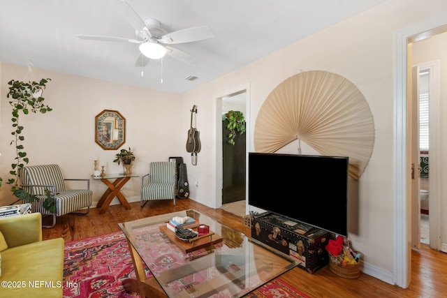 living room with ceiling fan and hardwood / wood-style flooring