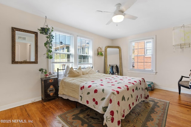 bedroom with hardwood / wood-style flooring and ceiling fan