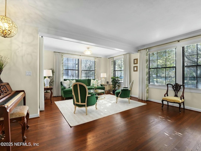 sitting room featuring ornamental molding and dark hardwood / wood-style flooring