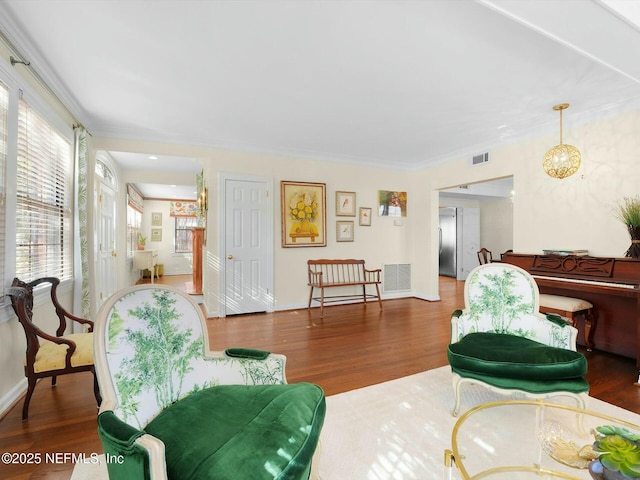 living room featuring crown molding and dark wood-type flooring