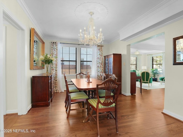 dining room featuring ornamental molding, a notable chandelier, and hardwood / wood-style flooring