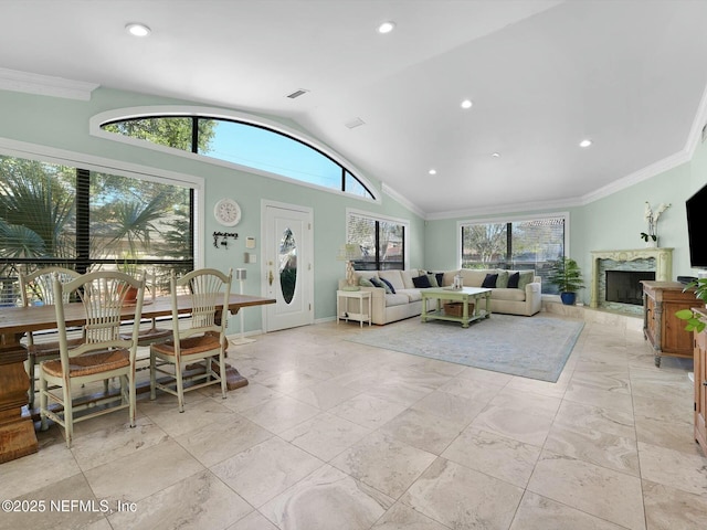 living room with high vaulted ceiling and ornamental molding