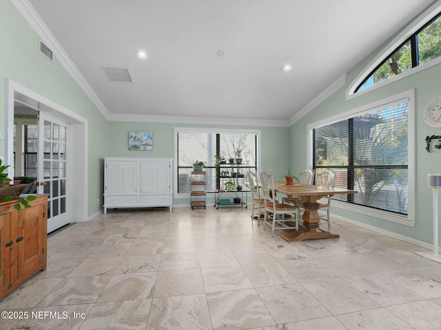 dining area with a healthy amount of sunlight, vaulted ceiling, and ornamental molding