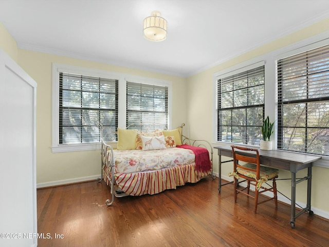 bedroom featuring dark hardwood / wood-style flooring, multiple windows, and crown molding