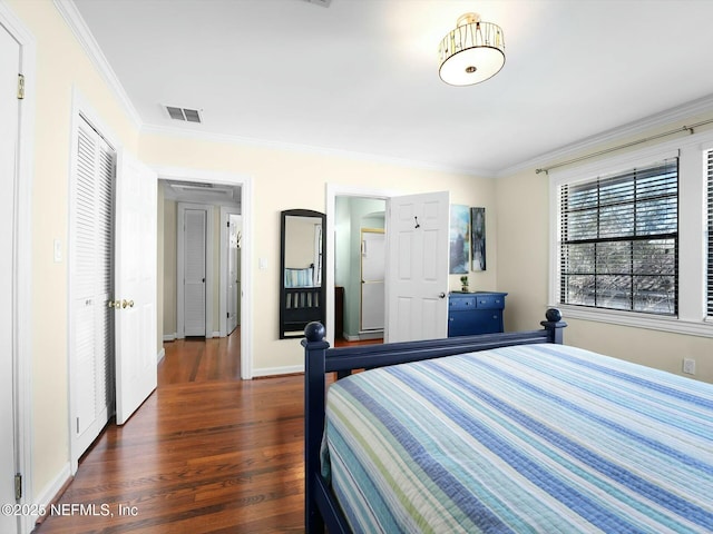 bedroom with dark wood-type flooring and crown molding