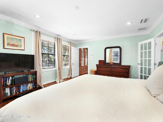 bedroom featuring hardwood / wood-style flooring and ornamental molding