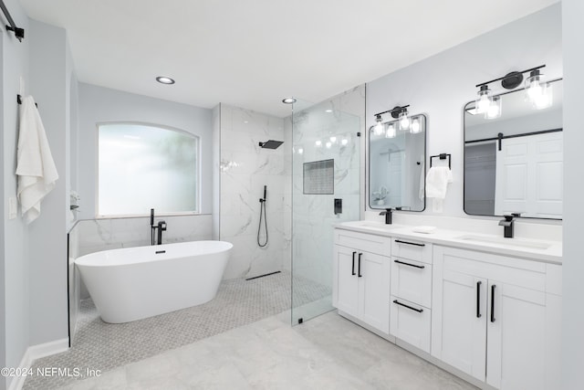 bathroom with vanity and shower with separate bathtub