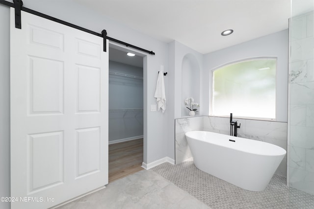 bathroom with a bath and tile patterned floors