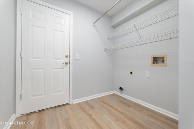 laundry area with hookup for an electric dryer, hardwood / wood-style flooring, and washer hookup