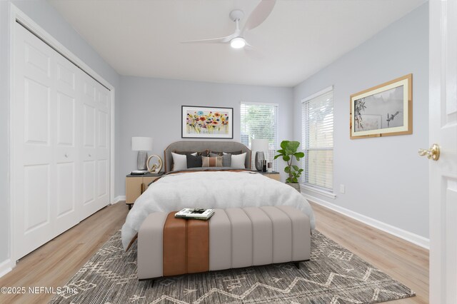 bedroom featuring hardwood / wood-style floors, a closet, and ceiling fan