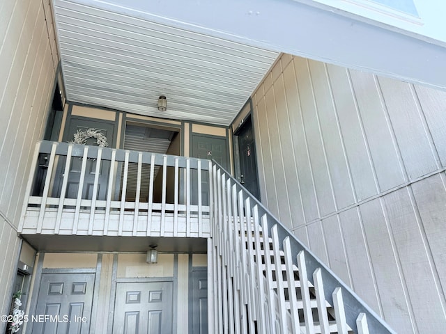 view of exterior entry with a balcony