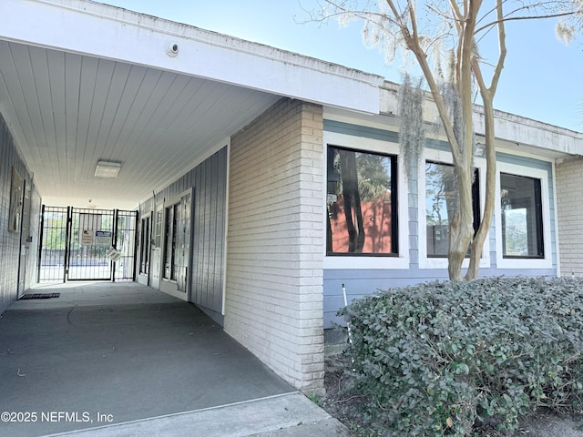 view of side of home with a carport