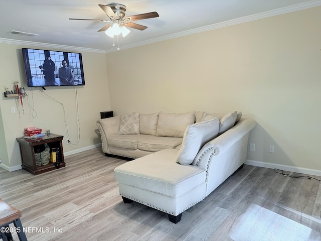 living room featuring crown molding, wood-type flooring, and ceiling fan