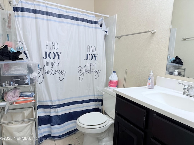 bathroom with tile patterned flooring, vanity, a shower with shower curtain, and toilet