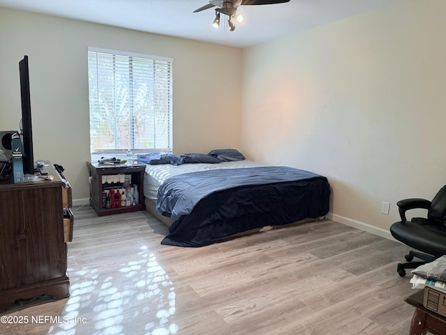 bedroom featuring light wood-type flooring and ceiling fan