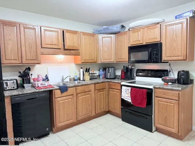 kitchen with sink, black appliances, and light tile patterned flooring