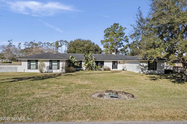 view of front of house with a front yard and a fire pit