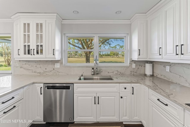 kitchen featuring dishwasher, white cabinets, a healthy amount of sunlight, and sink