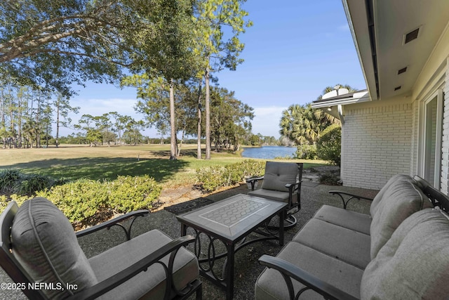 view of patio with a water view