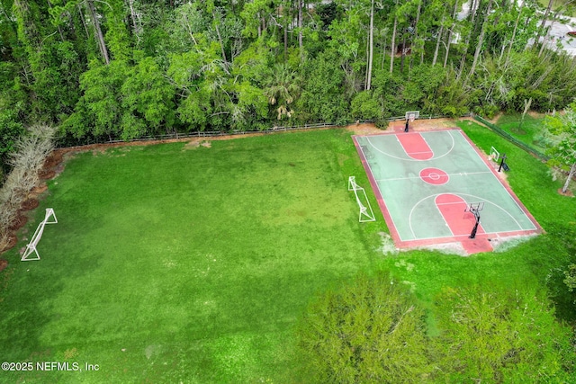 view of sport court featuring a lawn