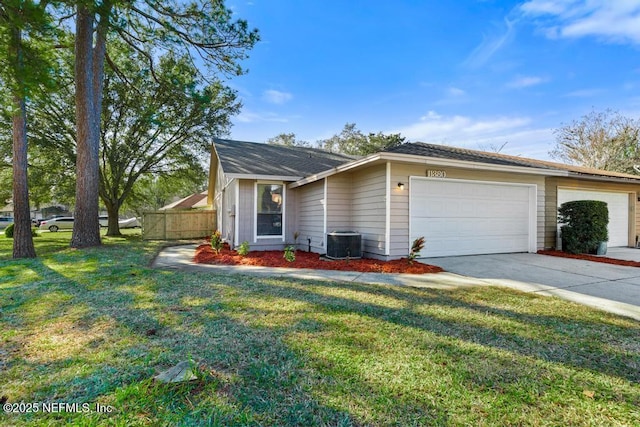 view of front facade featuring central AC unit, a garage, and a front lawn