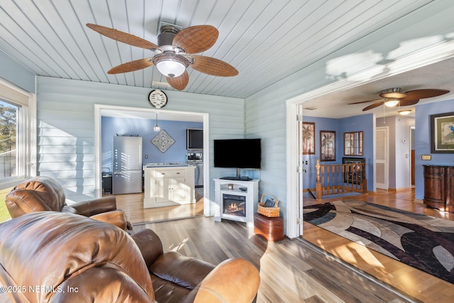 living room featuring wood-type flooring and wooden ceiling