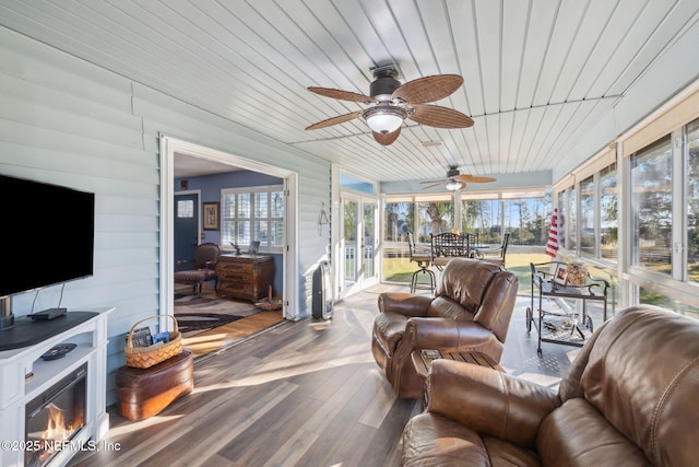 sunroom / solarium with ceiling fan and wooden ceiling