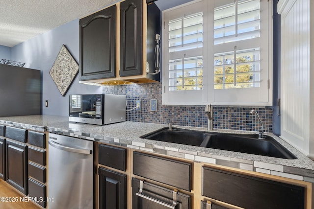 kitchen featuring dark brown cabinets, a textured ceiling, backsplash, and sink