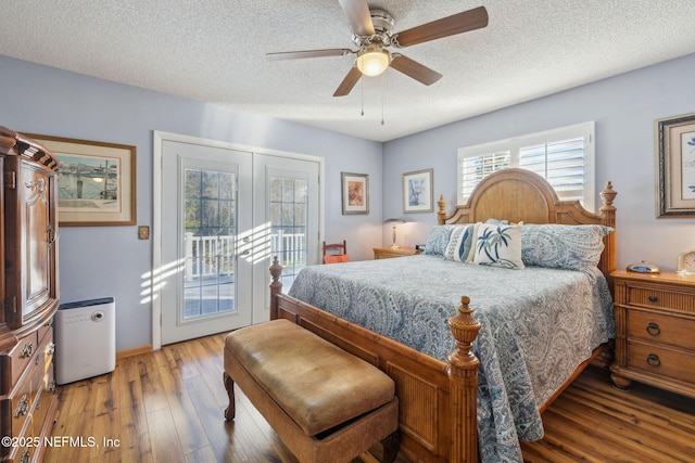 bedroom with access to outside, ceiling fan, wood-type flooring, and a textured ceiling