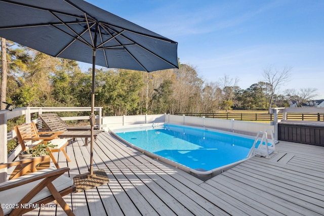 view of swimming pool featuring a wooden deck