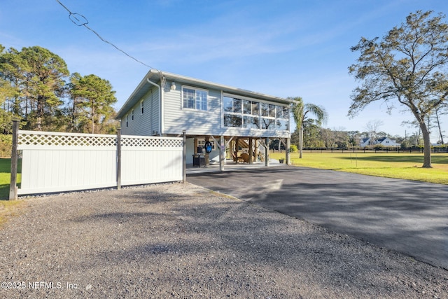 view of front of home with a front yard and a carport