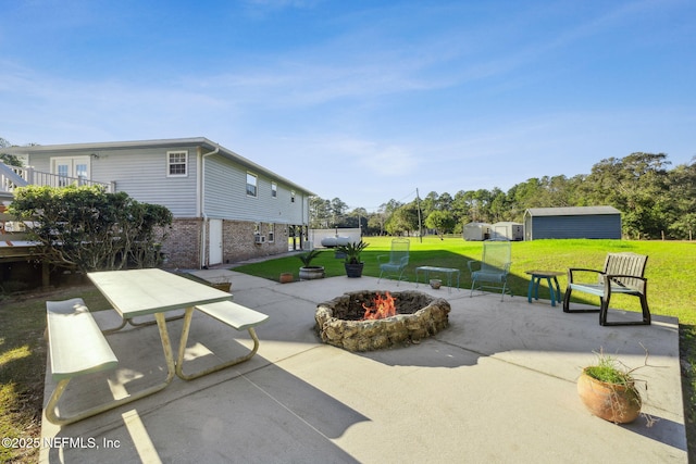 surrounding community featuring a yard, an outdoor fire pit, and a patio