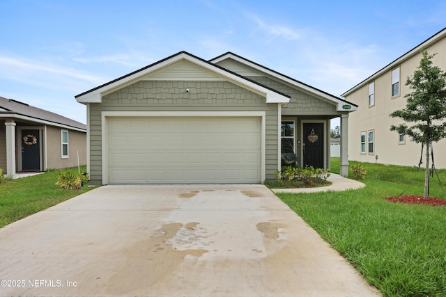 view of front of house featuring a front yard and a garage