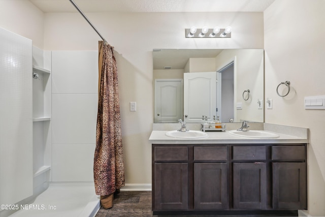 bathroom featuring hardwood / wood-style floors, vanity, and curtained shower