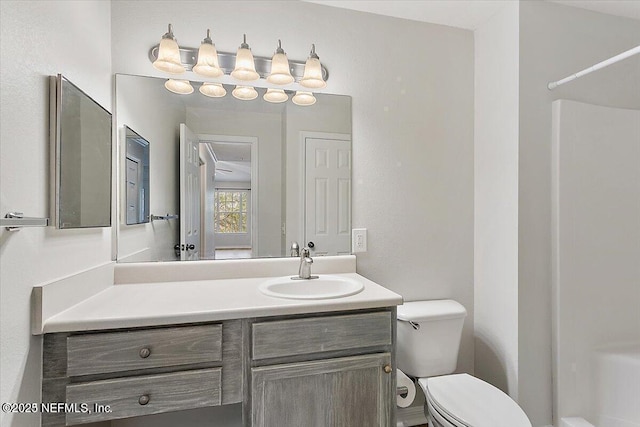 bathroom featuring vanity and toilet