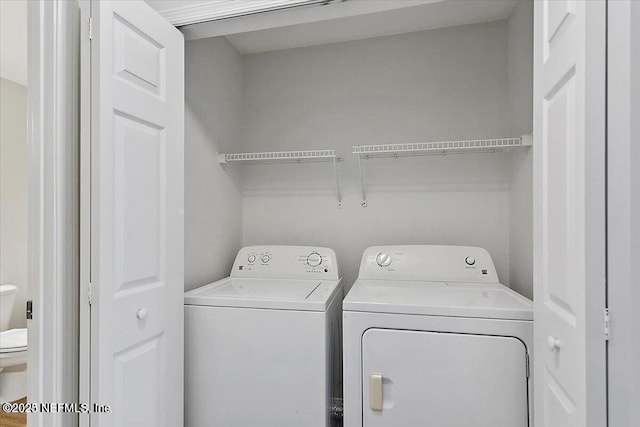 washroom featuring washing machine and dryer