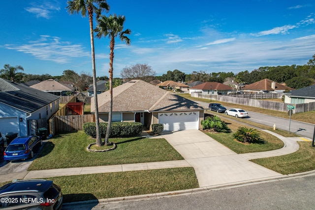 single story home with a residential view, driveway, a front lawn, and fence