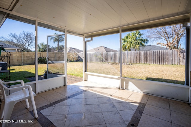 unfurnished sunroom with wood ceiling