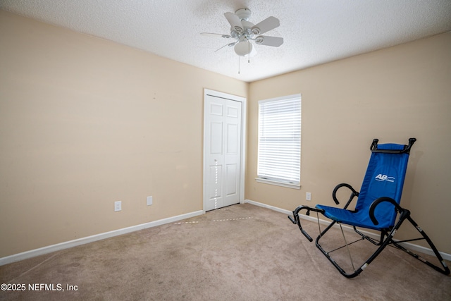 unfurnished room featuring ceiling fan, light carpet, and a textured ceiling