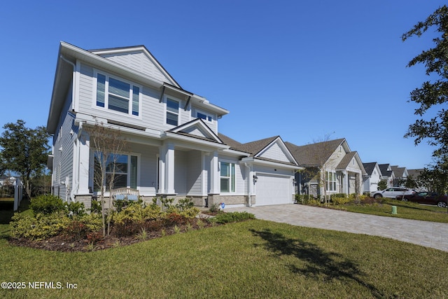 view of front facade featuring covered porch, a front yard, and a garage