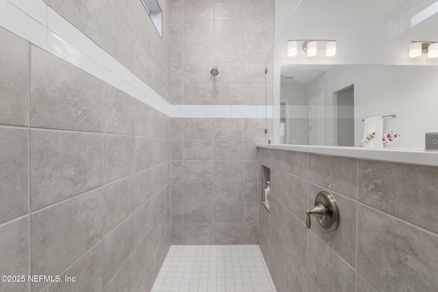 bathroom with a tile shower