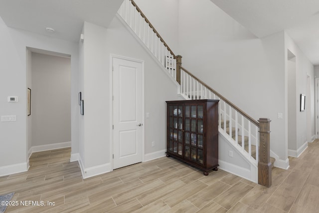 stairway with baseboards and wood finish floors