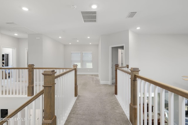 corridor featuring recessed lighting, visible vents, light carpet, and an upstairs landing