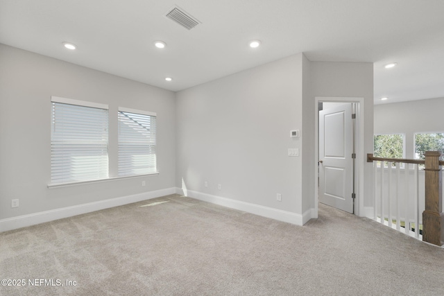 spare room featuring carpet floors, baseboards, visible vents, and recessed lighting