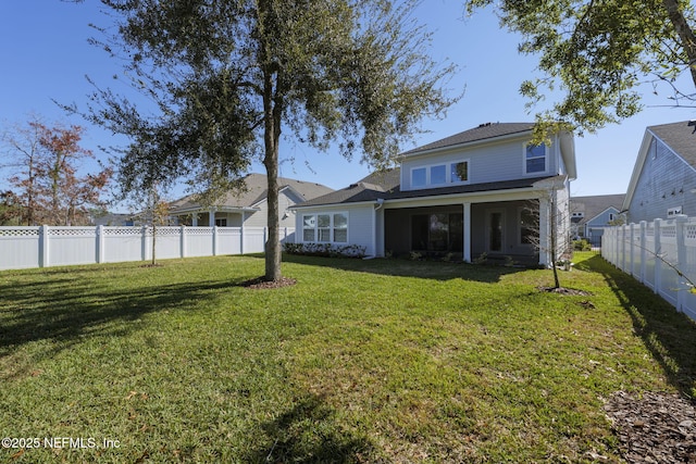 rear view of house with a lawn