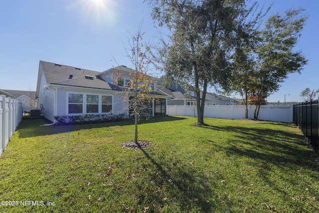 exterior space featuring central AC and a yard