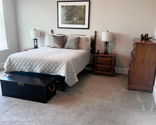 bedroom with carpet flooring and baseboards