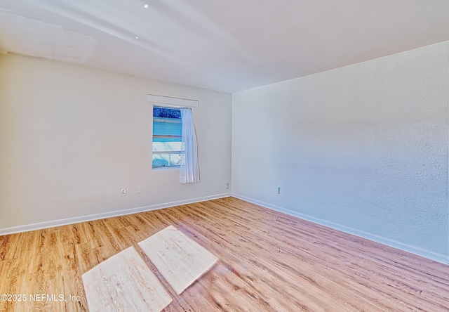 spare room featuring light hardwood / wood-style flooring