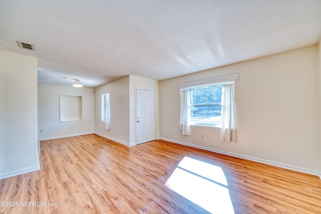 spare room with light hardwood / wood-style floors